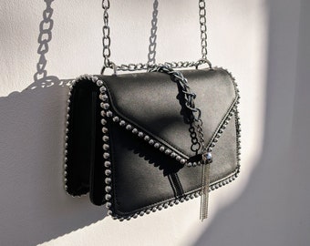 Black studded crossbody bag with a chain strap for women