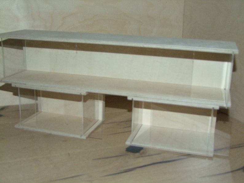 May include: A white wooden display case with two shelves and clear acrylic sides. The case is empty.