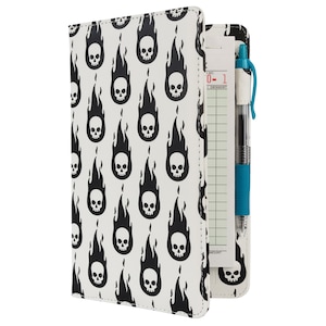 May include: A black and white notebook cover with a repeating pattern of skulls and flames. The cover has a built-in pen holder and a notepad with a check list.
