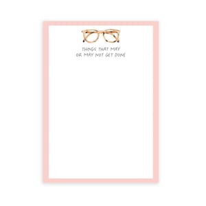May include: A pink notepad with a white interior and a black border. The notepad has a drawing of a pair of tortoiseshell glasses and the text "Things that may or may not get done".