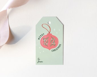 May include: A green gift tag with a red ornament and the text "Merry Christmas" on it. The tag has the words "to:" and "from:" at the bottom.