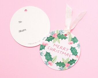 May include: Round white gift tag with a pink holly and berry design. The tag says "Merry Christmas" in pink lettering. The tag is attached to a white ribbon.