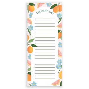 May include: A white grocery list notepad with a pink background and a border of orange citrus fruit slices and blue flowers. The text "Grocery List" is written in green at the top of the notepad.