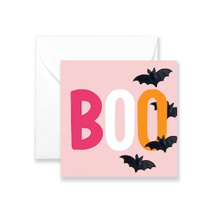 May include: A pink card with the word "BOO" in pink, white, and orange letters. Black bats are scattered around the letters.