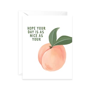 May include: A white greeting card with a watercolor illustration of a peach and green leaves. The card has the text "HOPE YOUR DAY IS AS NICE AS YOUR" in green letters. The card is inside a white envelope.