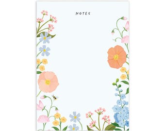 May include: A blue and white floral notepad with the word "NOTES" printed at the top. The notepad has a border of pink, orange, and blue flowers.