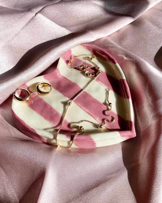 Handmade pink porcelain heart dish with jewel detailing — the kind of small-batch ceramic you'd actually display, not hide.
