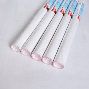 May include: Six rolls of clear adhesive shelf liner with red and white labels that say "transparent".