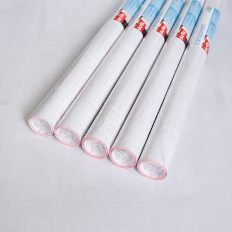 May include: Six rolls of clear adhesive shelf liner with red and white labels that say "transparent".