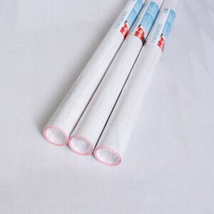 May include: Three rolls of white transparent contact paper with red and blue packaging. The packaging says "transparent" on it.
