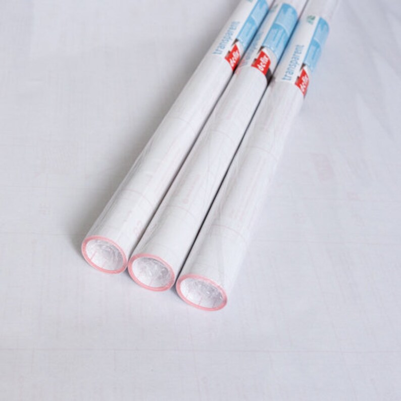 May include: Three rolls of white transparent contact paper with red and blue packaging. The packaging says "transparent" on it.