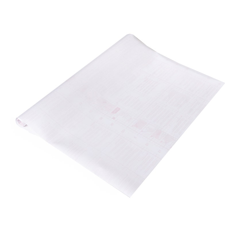 May include: A white sheet of paper with a faint grid pattern. The paper is rolled up at one end.