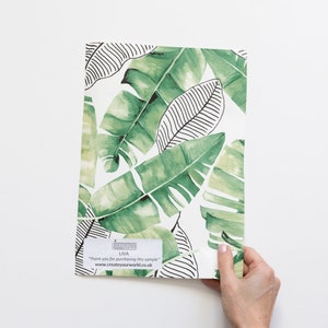 May include: A sample of green and white tropical leaf wallpaper with a black and white line design. The sample is labelled "CREATE LIVA" and includes the text "Thank you for purchasing this sample" and "www.createyourworld.co.uk".