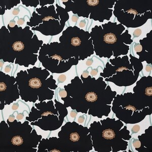 May include: A fabric with a repeating pattern of large black poppy flowers with tan centers and seed pods on a white background. The stems and leaves are a light green color. This floral design is suitable for home decor or apparel.