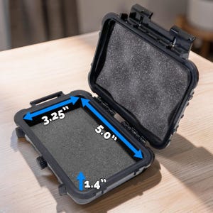 May include: Open black protective case with foam padding. The interior dimensions are 5.0" long, 3.25" wide, and 1.4" deep. The case is designed to protect small items from damage.