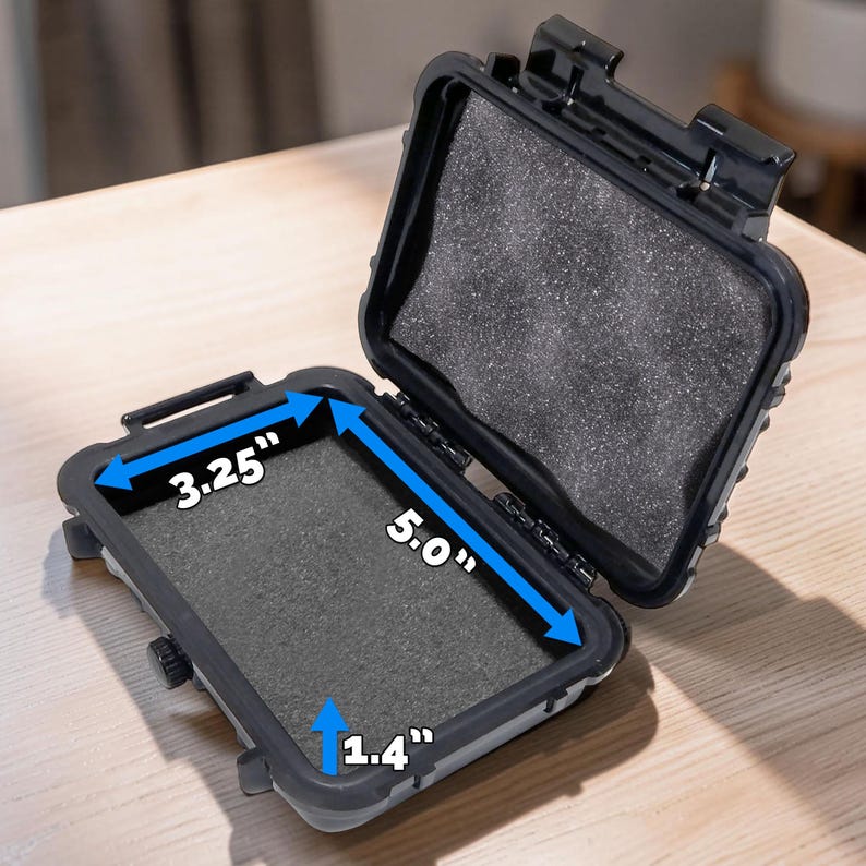 May include: Open black protective case with foam padding. The interior dimensions are 5.0" long, 3.25" wide, and 1.4" deep. The case is designed to protect small items from damage.