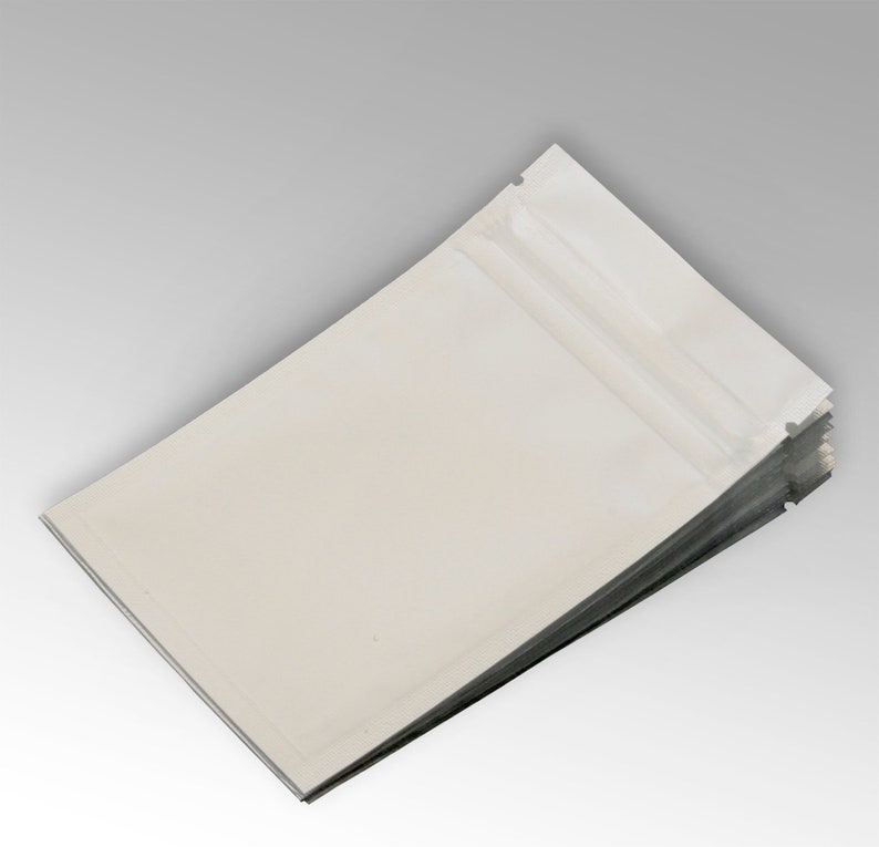 May include: A stack of white stand-up pouches with a clear zipper closure. The pouches are made of a flexible, durable material and are ideal for packaging a variety of products.