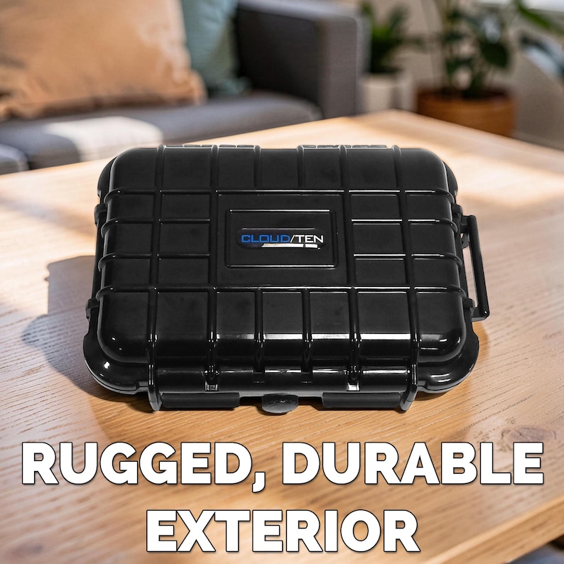 May include: A black, rectangular case with a textured, grid-like pattern. The case has a handle and a latch closure. The text "CLOUD/TEN" is printed in blue on the front. The words "RUGGED, DURABLE EXTERIOR" are printed in white below the case.