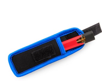 May include: A black and blue carrying case with a red and gold pen inside. The case has a velcro closure.