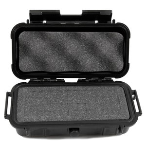 May include: Black hard plastic case with a foam interior. The case is open and the foam is visible. The case has a latch and a handle.