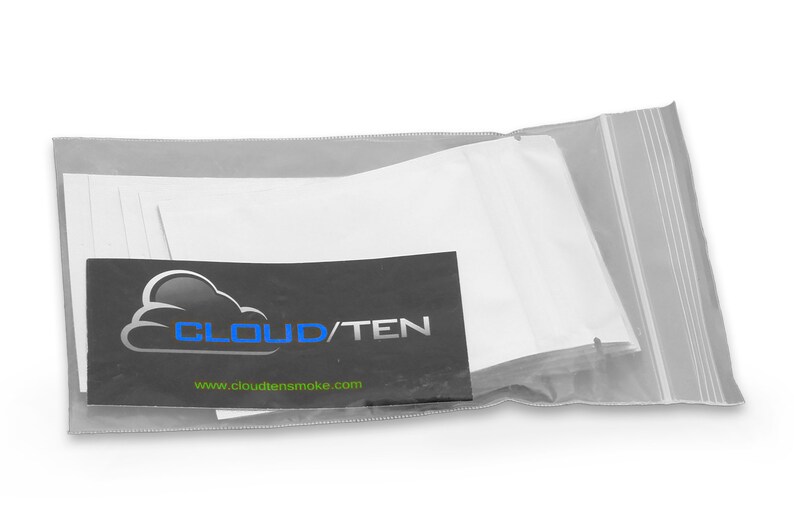May include: A clear plastic bag with a zipper closure containing a stack of white cotton pads. The bag has a black label with the text "CLOUD/TEN" and the website address "www.cloudtensmoke.com".