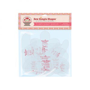 May include: A pack of clear plastic flower templates for quilting. The pack is pink and white with the text "Sew Simple Shapes™ by Lori Holt of Bee in my Bonnet" and "Flower Basket Sampler". The pack includes 50 templates.