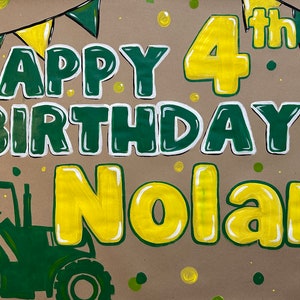 May include: A hand-painted birthday sign on brown paper. The words "HAPPY BIRTHDAY Nolan" are in green with white outlines, and "4th" is in yellow. A green tractor is in the lower left corner, with green and yellow bunting at the top.