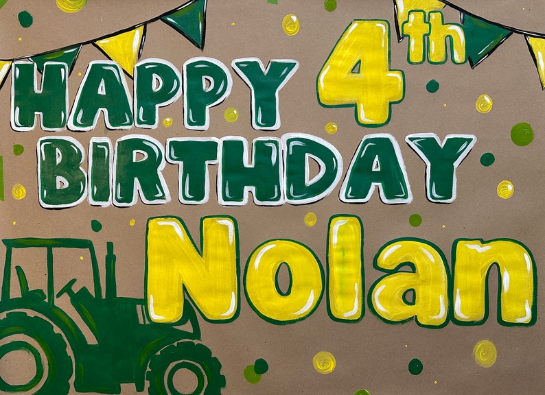 May include: A hand-painted birthday sign on brown paper. The words "HAPPY BIRTHDAY Nolan" are in green with white outlines, and "4th" is in yellow. A green tractor is in the lower left corner, with green and yellow bunting at the top.