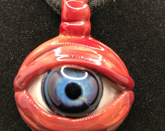 Glass Blue eye pendant with red eyelids and flower implosion on the back