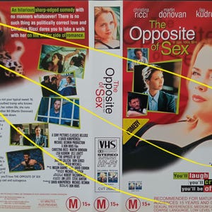 May include: VHS movie cover for "The Opposite of Sex" featuring Christina Ricci. The cover has a red background with images of the cast and the film's title. The cover includes text that reads "You'll laugh, you'll cry, you'll be offended!"