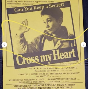 May include: A vintage movie poster for "Cross my Heart" with a yellow background and black text. The poster features a black and white image of a young person and quotes from critics. The film was voted one of the most popular at film festivals.