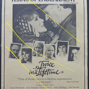 May include: A vintage movie poster for "Twice in a Lifetime" featuring Gene Hackman and Ann-Margret. The black and white poster includes images of the cast and the film's title in a stylized font. The poster also includes text from the New York Post.