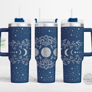 May include: A blue stainless steel tumbler with a silver design of a moon, stars, and flowers. The tumbler has a lid and a handle.
