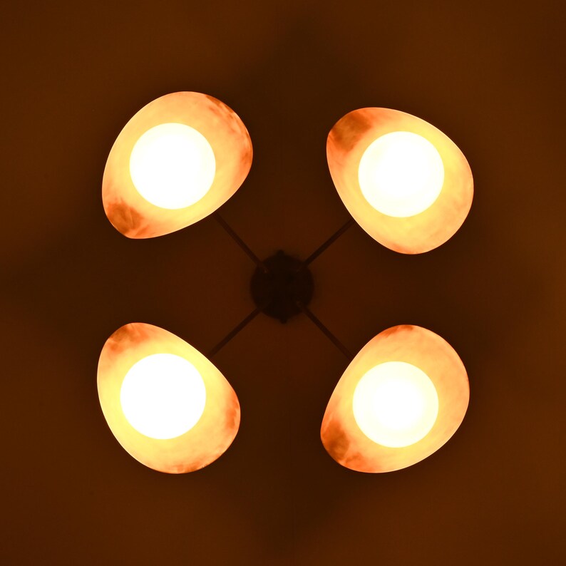 Contemporary Brass Chandelier With Four Globe Lights And Curved Copper Finish Shades, Warm Ambient Lighting