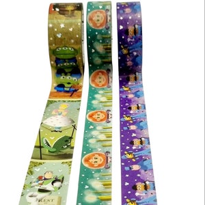 May include: Three rolls of washi tape featuring characters from the Disney Pixar movie Toy Story. The first roll features Woody, Buzz Lightyear, and the aliens. The second roll features a green background with a repeating pattern of a girl with red hair and a candle. The third roll features a purple background with a repeating pattern of a bee and a man in a blue suit.