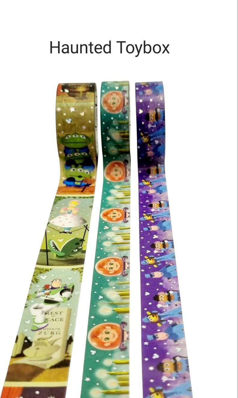 May include: Three rolls of washi tape featuring characters from the Disney Pixar movie Toy Story. The first roll features Woody, Buzz Lightyear, and the aliens. The second roll features a green background with a repeating pattern of a girl with red hair and a candle. The third roll features a purple background with a repeating pattern of a bee and a man in a blue suit.