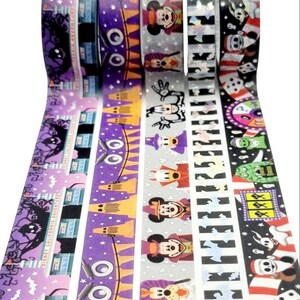 May include: Five rolls of washi tape featuring a Halloween theme with Mickey Mouse and other Disney characters. The tape is purple, orange, grey, black, and white with a variety of designs including ghosts, bats, and stars.