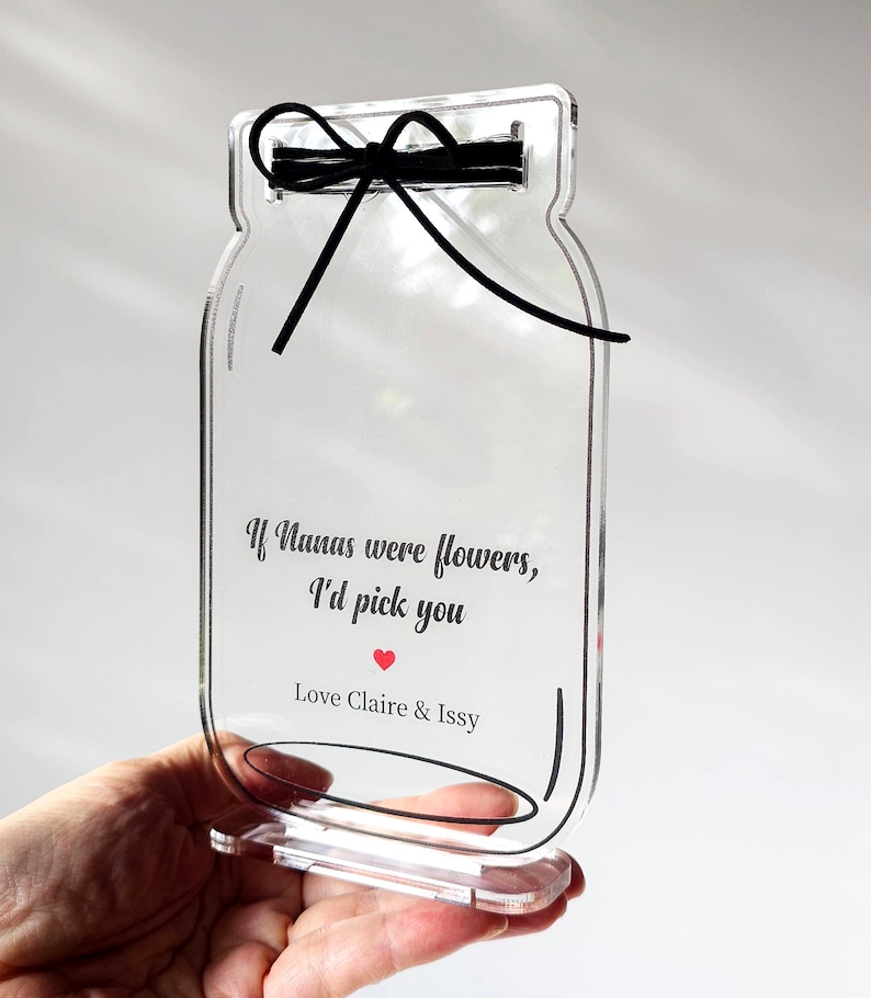 May include: Clear acrylic mason jar with a black ribbon and the text "If Nanas were flowers, I'd pick you" with a red heart and "Love Claire & Issy".