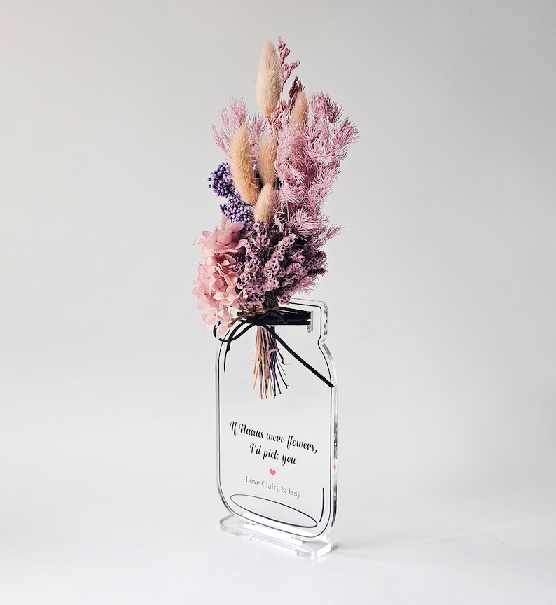 May include: A clear acrylic vase with a bouquet of dried flowers in shades of pink and purple. The vase has a quote on it that reads "If humans were flowers, I'd pick you."  Love Claire & Issy.