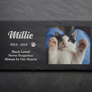 May include: Black and white cat memorial slate with a photo of the cat, the name Millie, the dates 2012 - 2024, a paw print, and the text "Much Loved, Never Forgotten, Always In Our Hearts".