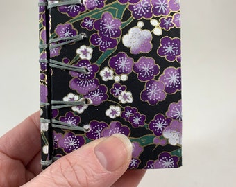 Unlined small / mini Secret Belgian binding white text paper journal, sketchbook, notebook, purple, black cherry blossoms covers
