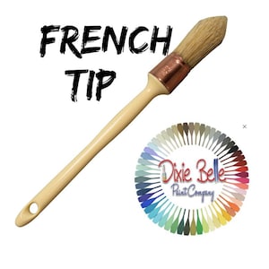 May include: A French tip paintbrush with a light wood handle and natural bristles. The brush has a copper ferrule and is angled for precision painting. The text "FRENCH TIP" is above the brush. The Dixie Belle Paint Company logo is in the lower right.