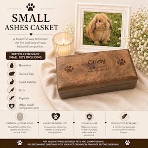 May include: A rectangular dark brown wooden casket for small pet ashes featuring a magnetic closure. The lid is engraved with the name Cindy, the dates 2000-2018, the text Never forgotten xxx, and two paw prints. The casket is shown with a candle and photo.