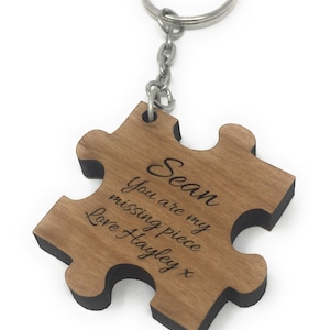 May include: Wooden puzzle piece keyring with the text "Sean you are my missing piece Love Hayley x" engraved on it.