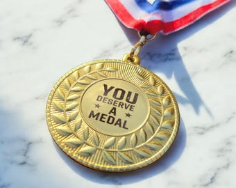 Gold Medal Engraved 'You Deserve A Medal' - Leaf Pattern, Free Delivery Free Ribbon. Joke Gift Funny Medal. Mothers Day Mum Deserves a Medal