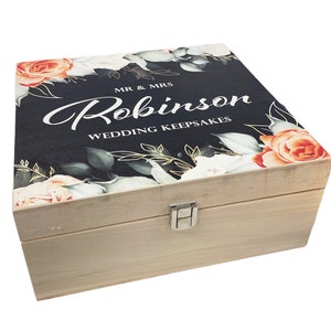 May include: A wooden keepsake box with a floral design and the text "Mr & Mrs Robinson Wedding Keepsakes".