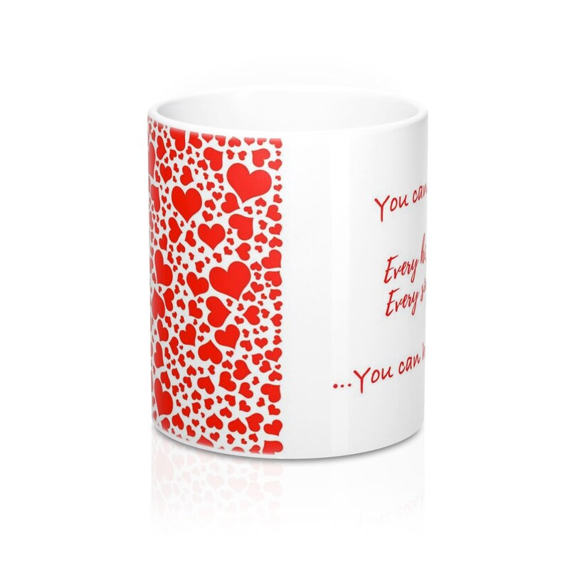 May include: White ceramic mug with a red heart pattern on the side and red text. The heart pattern is composed of various sizes of red hearts. The text on the mug reads "You can... Every day... Every way... You can..."