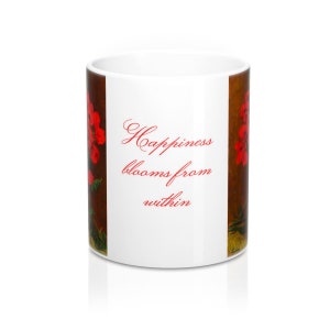 May include: White ceramic mug with a floral design and the text "Happiness blooms from within" in red script. The mug features a brown background with red flowers.