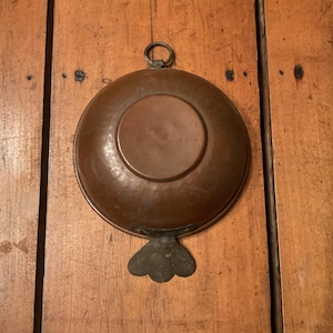 May include: A handmade wooden sign with the text "Welcome to our home" in a handwritten style. The sign is painted white with a dark stained wooden frame. A small, decorative heart is attached to the sign.