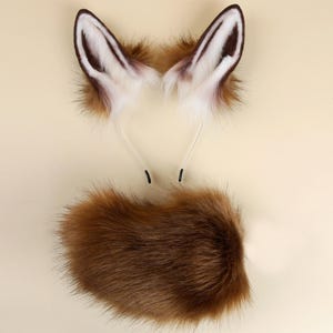 May include: A brown and white faux fur fox tail and a matching pair of fox ears with a headband.